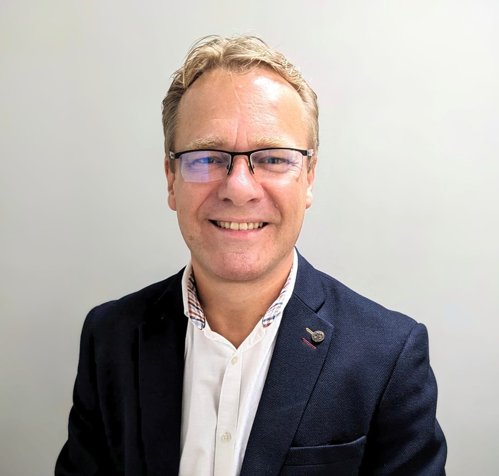 A headshot of a man, Adrian Green, Chair of the North Yorkshire Safeguarding Adults Board